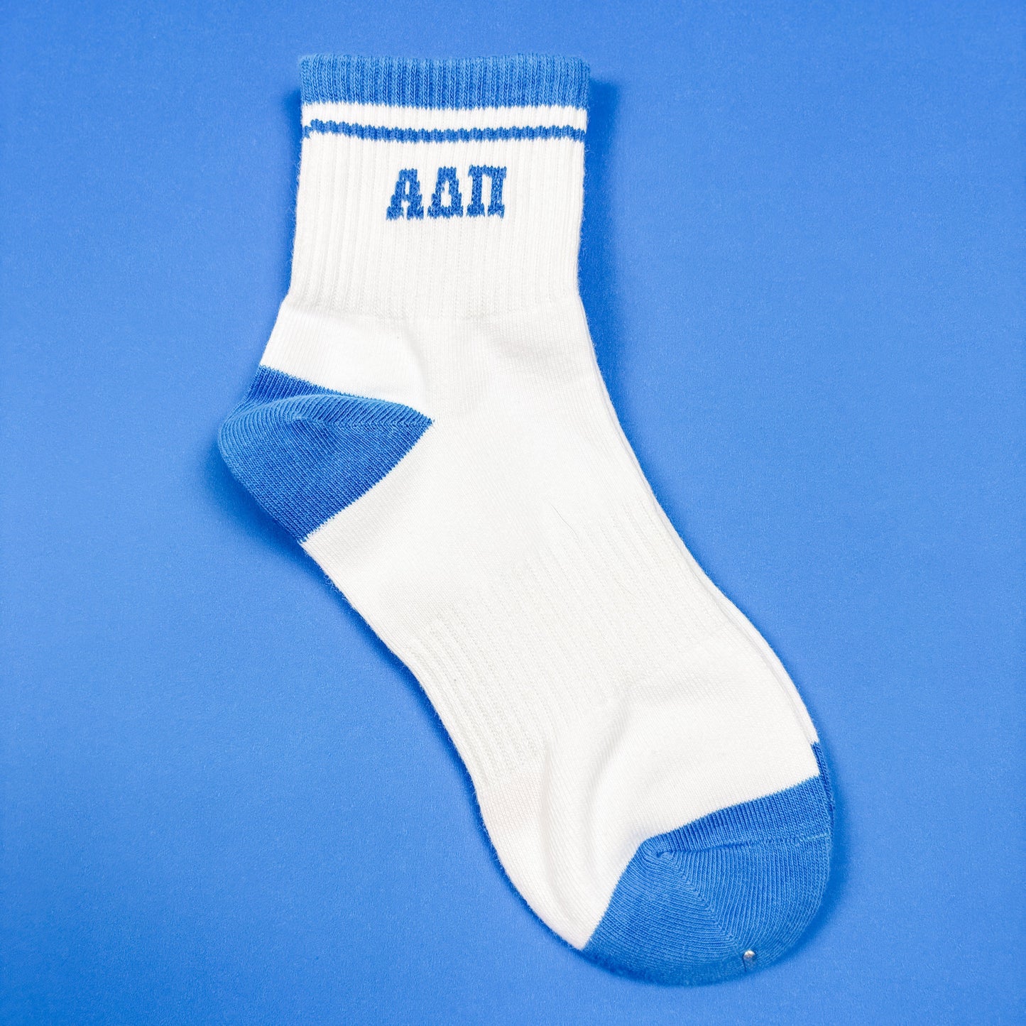 White sock with blue accents and 'AAP' text on a blue background