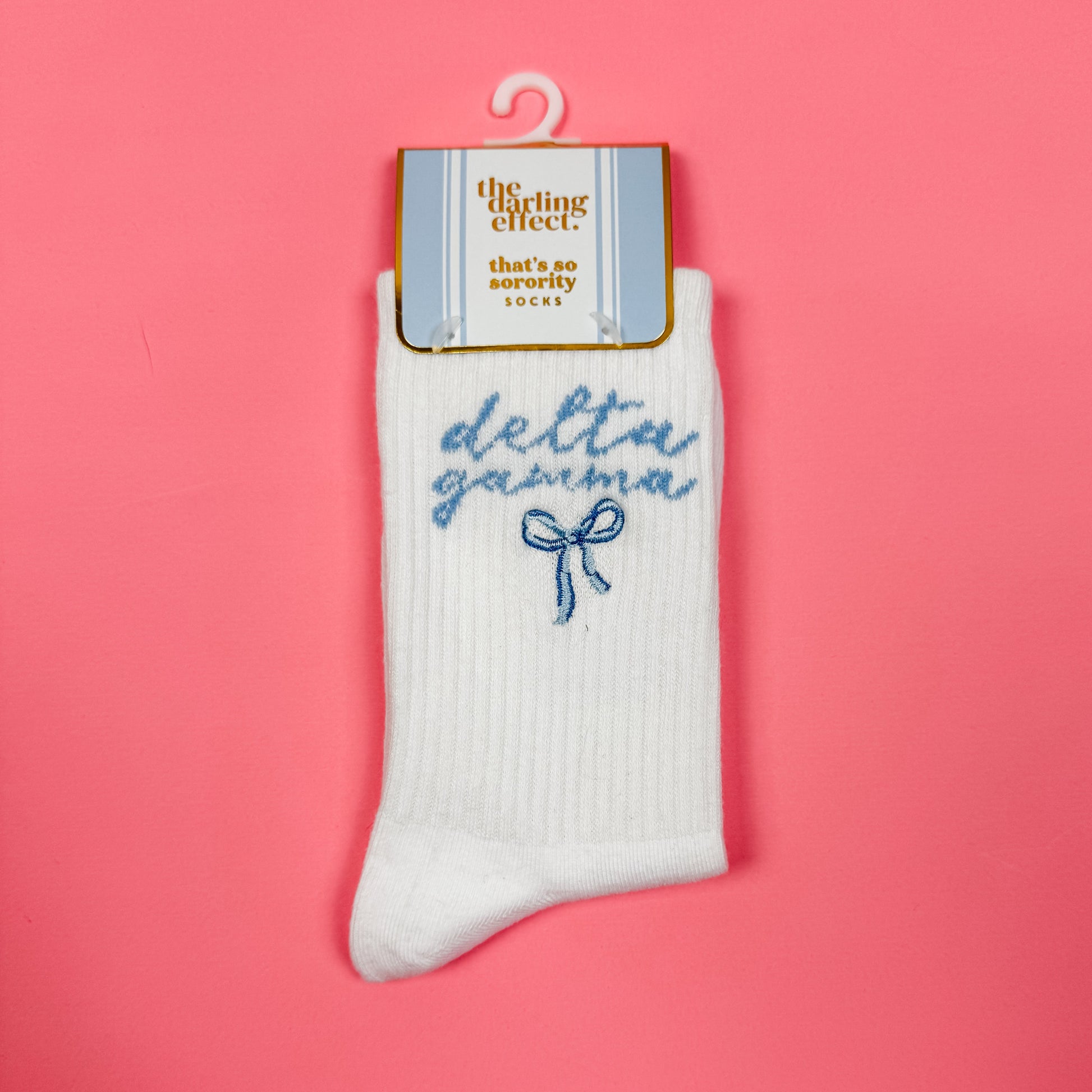 White sock with blue text on a pink background