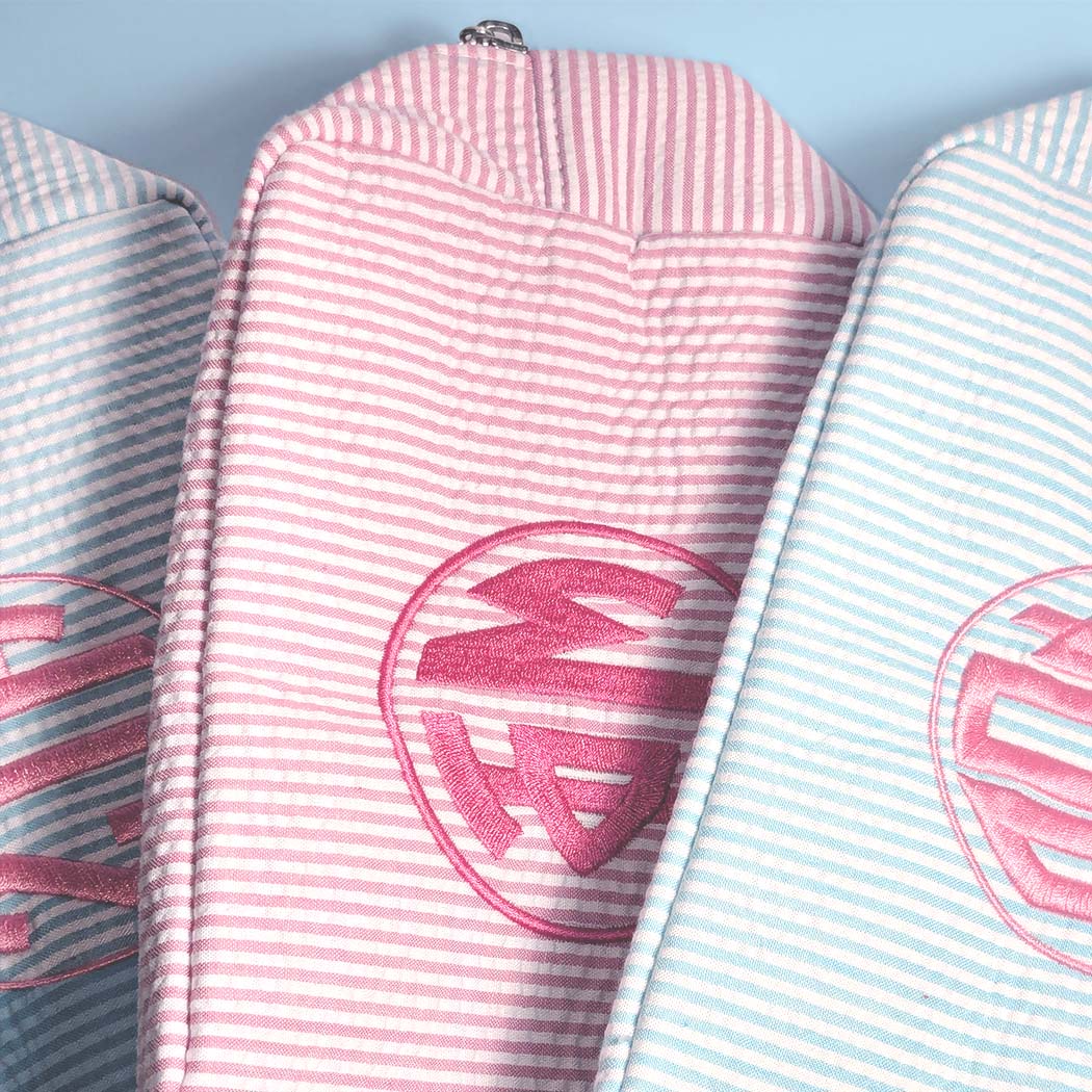 Three striped bags with a logo on a light blue background